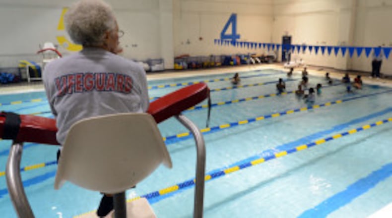 Lifeguard Emma Sistrunk keeps an eye on the pool as Martin Luther King Jr. Middle School students participate in a swimming lesson.