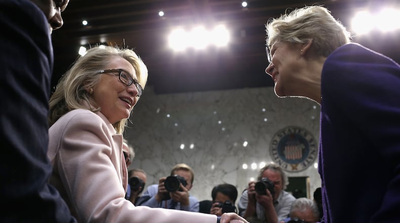 U.S. Secretary of State Hillary Clinton (L) greets Sen. Elizabeth Warren (D-MA) as they arrive for Sen. John Kerry's (D-MA) confirmation hearing before the Senate Foreign Relations Committee to become the next Secretary of State in the Hart Senate Office Building on Capitol Hill January 24, 2013 in Washington, DC. Nominated by President Barack Obama to succeed Hillary Clinton as Secretary of State, Kerry has served on this committee for 28 years and has been chairman for four of those years. (Photo by Chip Somodevilla/Getty Images)