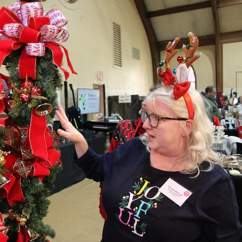 Kendra Beneigh, co-owner of Krafty Kreations, showcases her mother Karen’s decorative mailbox covers at the 43rd Annual Apple Annie Arts and Crafts Show Friday.