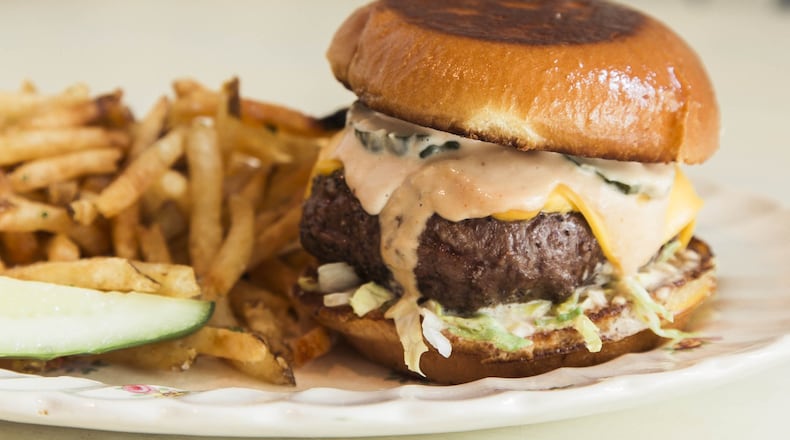 Spies Like Us Burger topped with American cheese, Soviet Sauce, spicy house-made B&B pickles, and shredded lettuce. PHOTO CREDIT: Tomas Espinoza