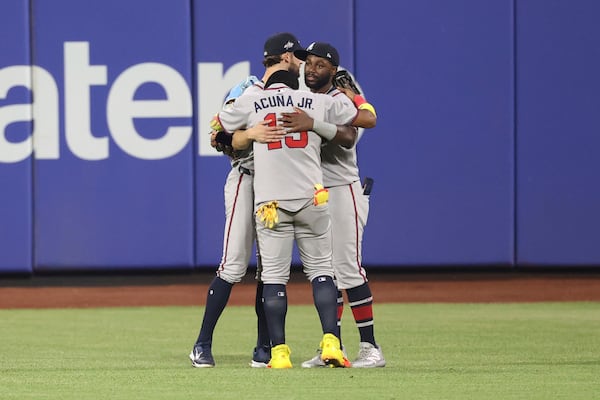From left to right, Atlanta Braves outfielders Eli White, Ronald Acuña Jr. and Michael Harris II react after defeating the New York Mets in a baseball game Monday, June 23, 2025, in New York. (AP Photo/Pamela Smith)