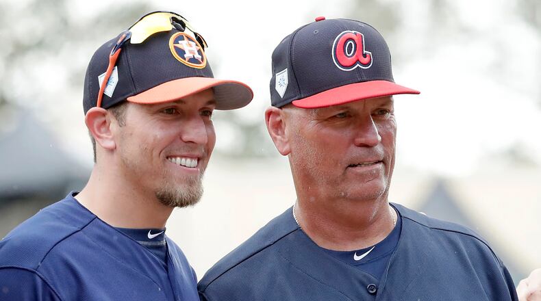 Houston Astros hitting coach Troy Snitker, (left) poses with his father, Braves manager Brian Snitker, before a spring exhibition game, Monday, March 4, 2019, in Kissimmee, Fla. No matter how this year’s World Series ends, a Snitker will get a championship ring. (John Raoux/AP)