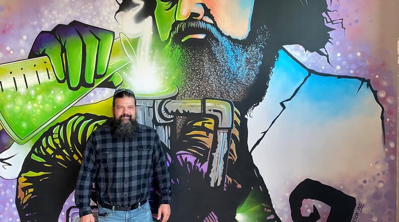 Though 2020 was a tough year, there were openings, including Dr. Scofflaw’s Laboratory and Beer Garden. Here, Scofflaw Brewing co-founder and chief brewing officer Travis Herman is at the new seven-barrel research and development brewery and taproom at the Works in Atlanta. (Bob Townsend for the Atlanta Journal-Constitution)