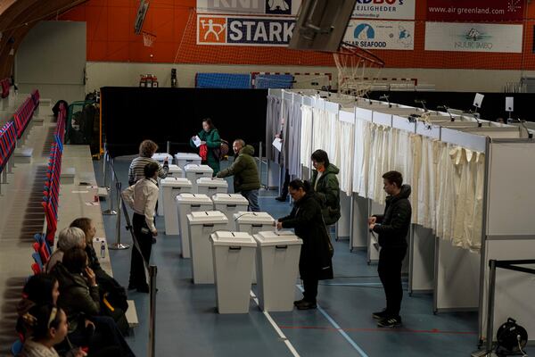 People cast their votes in parliamentary elections in Nuuk, Greenland, Tuesday, March 11, 2025. (AP Photo/Evgeniy Maloletka)