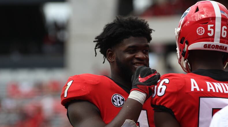 Georgia outside linebacker Brenton Cox (1) talks to Georgia outside linebacker Adam Anderson (56) during the Middle Tennessee State game last September at Stanford Stadium.