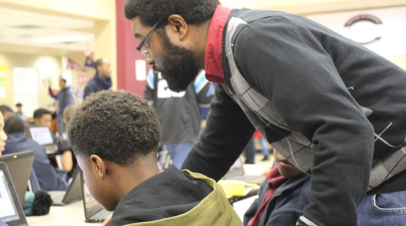 Samuel Stephens, then lead sixth grade teacher at the Fulton Leadership Academy, worked closely with a student in 2020. The State Charter Schools Commission voted Wednesday, Feb. 28, 2024, to close the school at the end of this school year due to academic and financial concerns. The commission had similar reasons for approving the closure of Cherokee Charter Academy at the same meeting. (AJC file photo)