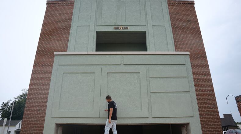 Wesley Mast, owner and president of Coppes Napanee, walks past a giant replica of a Hoosier cabinet in Nappanee, Ind., Thursday, Aug. 6, 2026. (AP Photo/Obed Lamy)