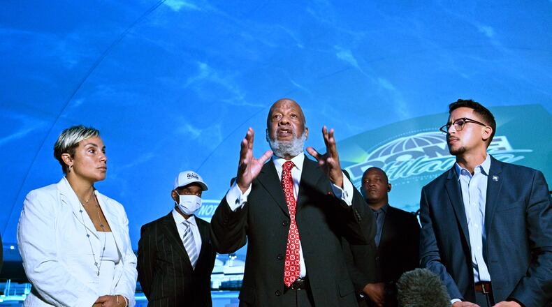 May 25, 2021 Atlanta - Bishop JohnÊH.ÊLewis, chairman of theÊVine CityÊCivic Association,  speaks as Michelle Falconer (left) and AtlantaÊCityÊCouncilman Antonio Brown look during a press conference Inside Dome Atlanta, transient event venue, across the street from the Mercedes-Benz Stadium on Tuesday, May 25, 2021. Dome in the City is a state-of-the-art DIGITAL event center. Twenty four projectors illuminate the entire interior and exterior of this temperature-controlled, transient venue, according to their website. (Hyosub Shin / Hyosub.Shin@ajc.com)