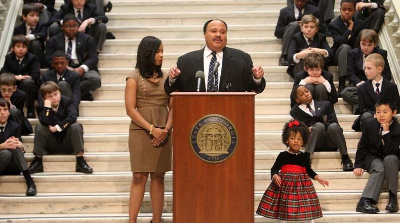 Martin Luther King III speaks alongside his wife, Arndrea, and 2-year-old daughter, Yolanda, at the Rev. Martin Luther King Jr. tribute at the state Capitol last Thursday.