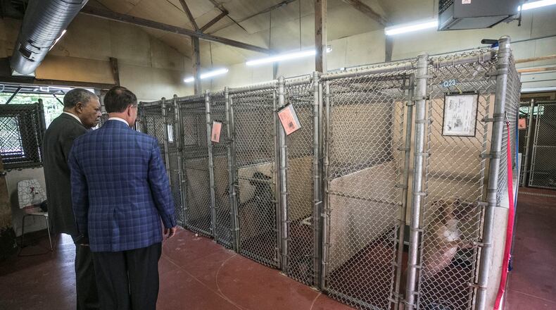 Fulton County Chairman Robb Pitts (left) and County Manager Dick Anderson get a tour of the Fulton County animal shelter last month. (Photo: Bob Andres / bandres@ajc.com)