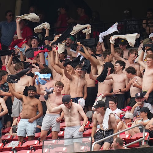 Fans cheer and wave their shirts above their heads during the fourth inning of a baseball game between the St. Louis Cardinals and the Kansas City Royals Saturday, May 16, 2026, in St. Louis. (AP Photo/Jeff Roberson)