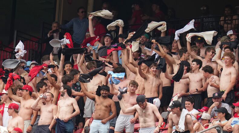 Fans cheer and wave their shirts above their heads during the fourth inning of a baseball game between the St. Louis Cardinals and the Kansas City Royals Saturday, May 16, 2026, in St. Louis. (AP Photo/Jeff Roberson)