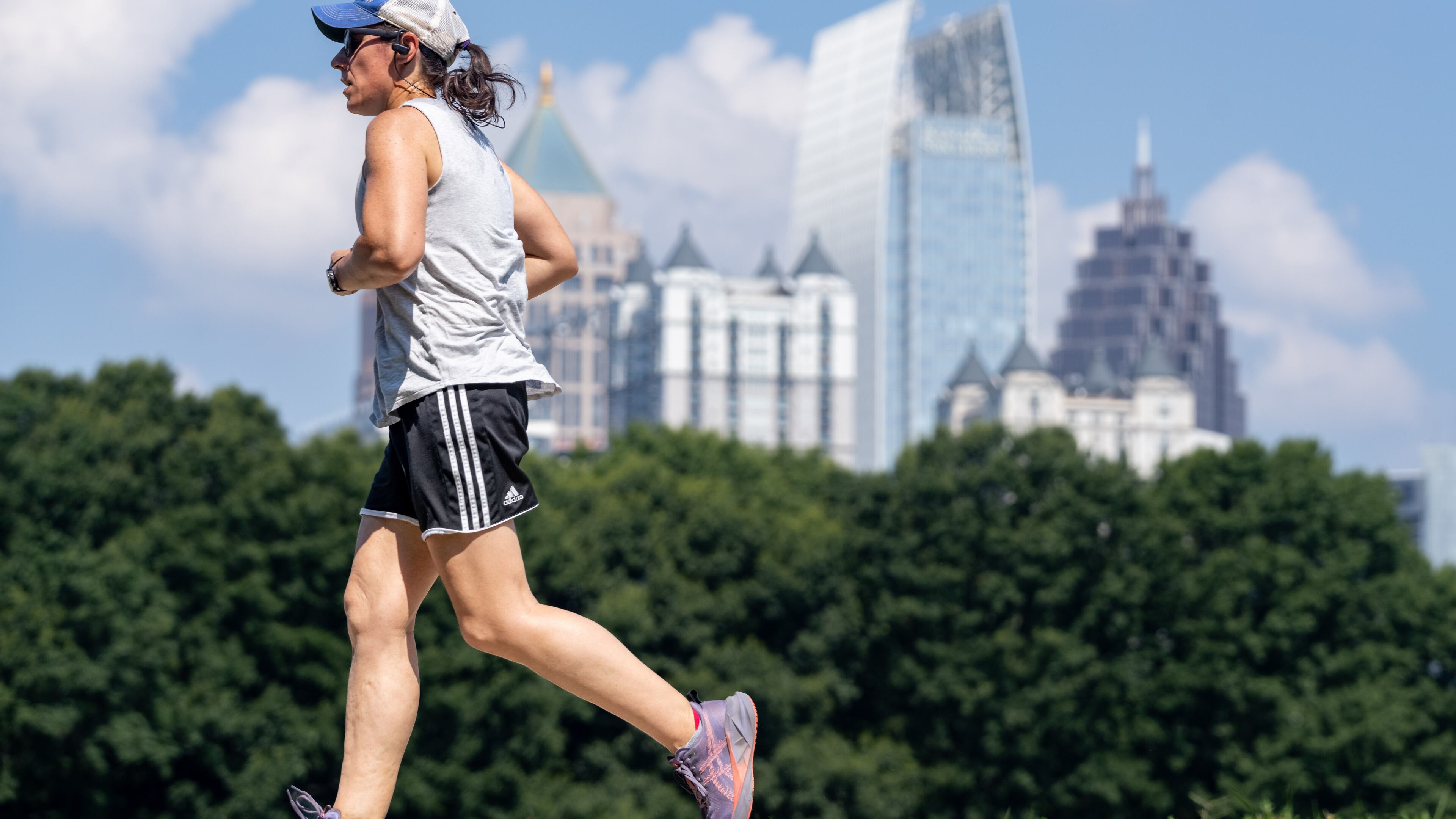A woman runs in Atlanta's Piedmont Park as temperatures climb toward — and above — 90 degrees on Tuesday, June 24, 2025. Wednesday is another scorcher in Georgia. (Ben Hendren for the AJC)