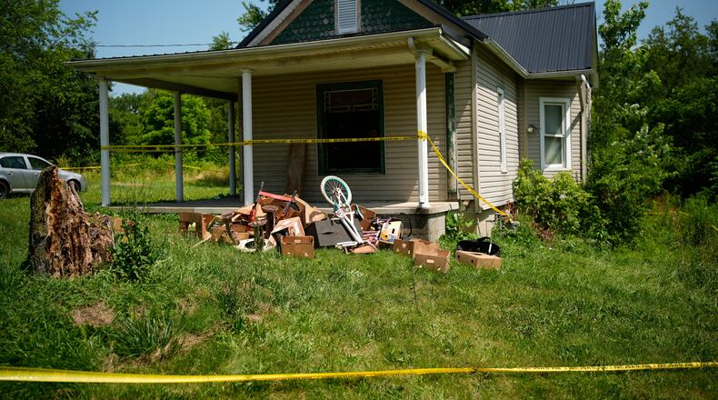 Police tape surrounds a home where authorities say they removed 16 children and arrested four adults in Hamden, Ohio, Wednesday, July 1, 2026. (AP Photo/Carolyn Kaster)