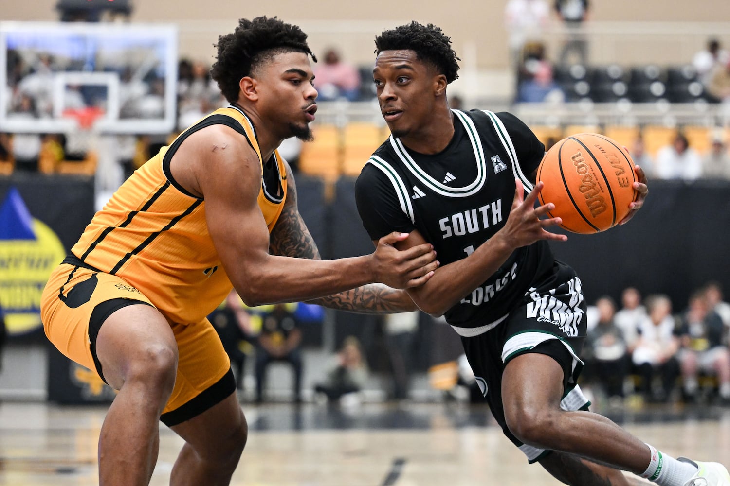 Kennesaw State guard RJ Johnson (left) guards South Florida forward CJ Brown (right) during the first half of a game Sunday, Nov. 16, 2025 at Kennesaw State University. (Daniel Varnado for the AJC)