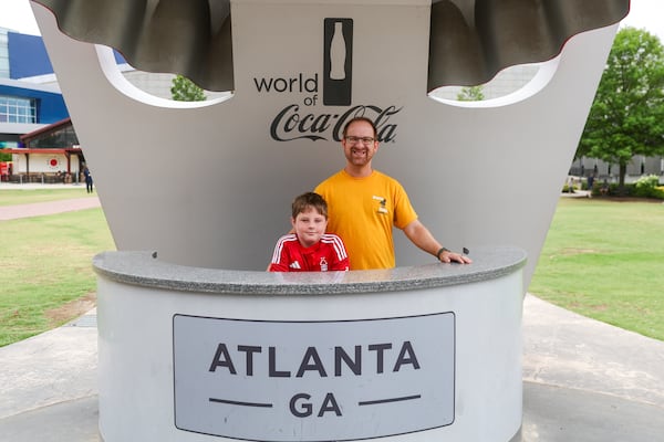 Ross Rechen from Houston, Texas, and family member Mason Challinor, 11, visited the World of Coca-Cola on Saturday, July 19, 2025, in Atlanta. Rechen said he might prefer the taste of cane sugar, but he worried about the economic impacts of changing a major Coca-Cola ingredient. (Abbey Cutrer/AJC)