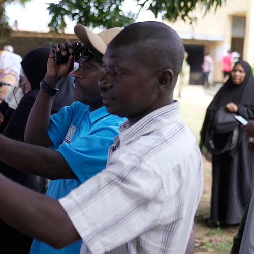 Voters verify their names before voting during the general elections at Mpendaye polling station in Zanzibar, Tanzania, Wednesday, Oct. 29, 2025. (AP Photo/Brian Inganga)
