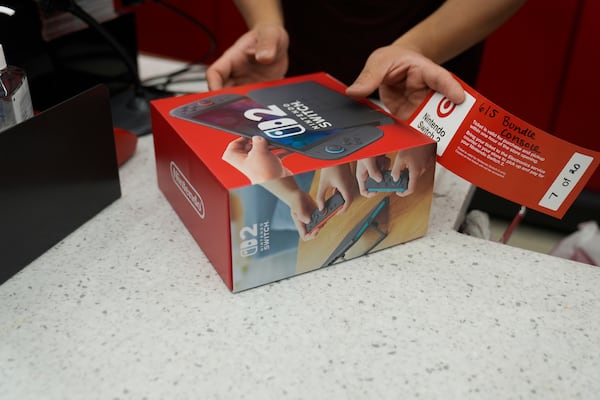 A customer receives the new Nintendo Switch 2 video game console at a Target store on Thursday, June 5, 2025 in Chicago. (AP Photo/Kiichiro Sato)