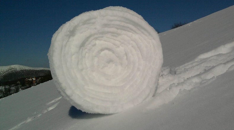 This is a snow roller and a rather large. They form only under perfect conditions involving snow, wind, moisture and temperature.