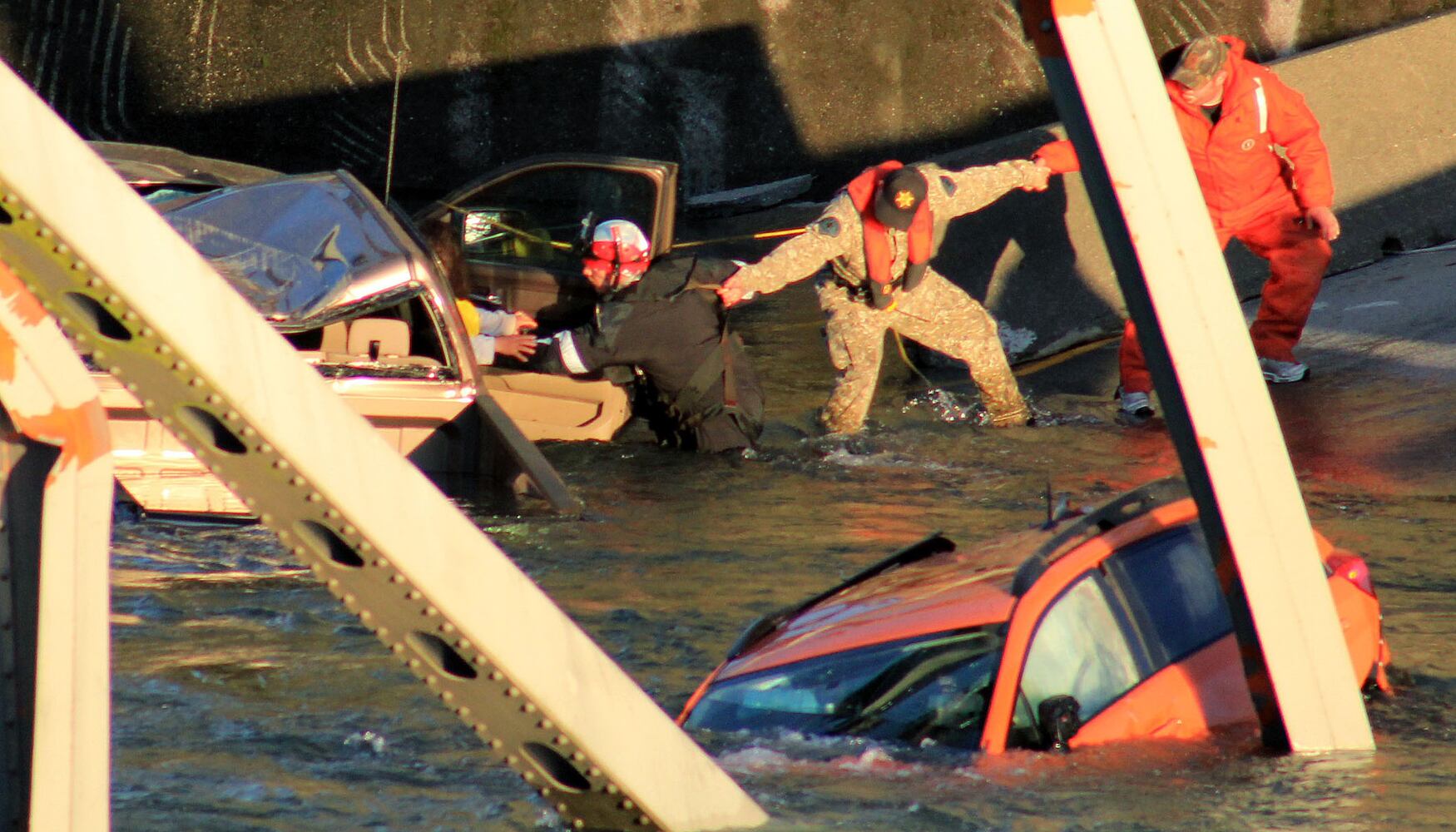 Vehicles, people dumped into water