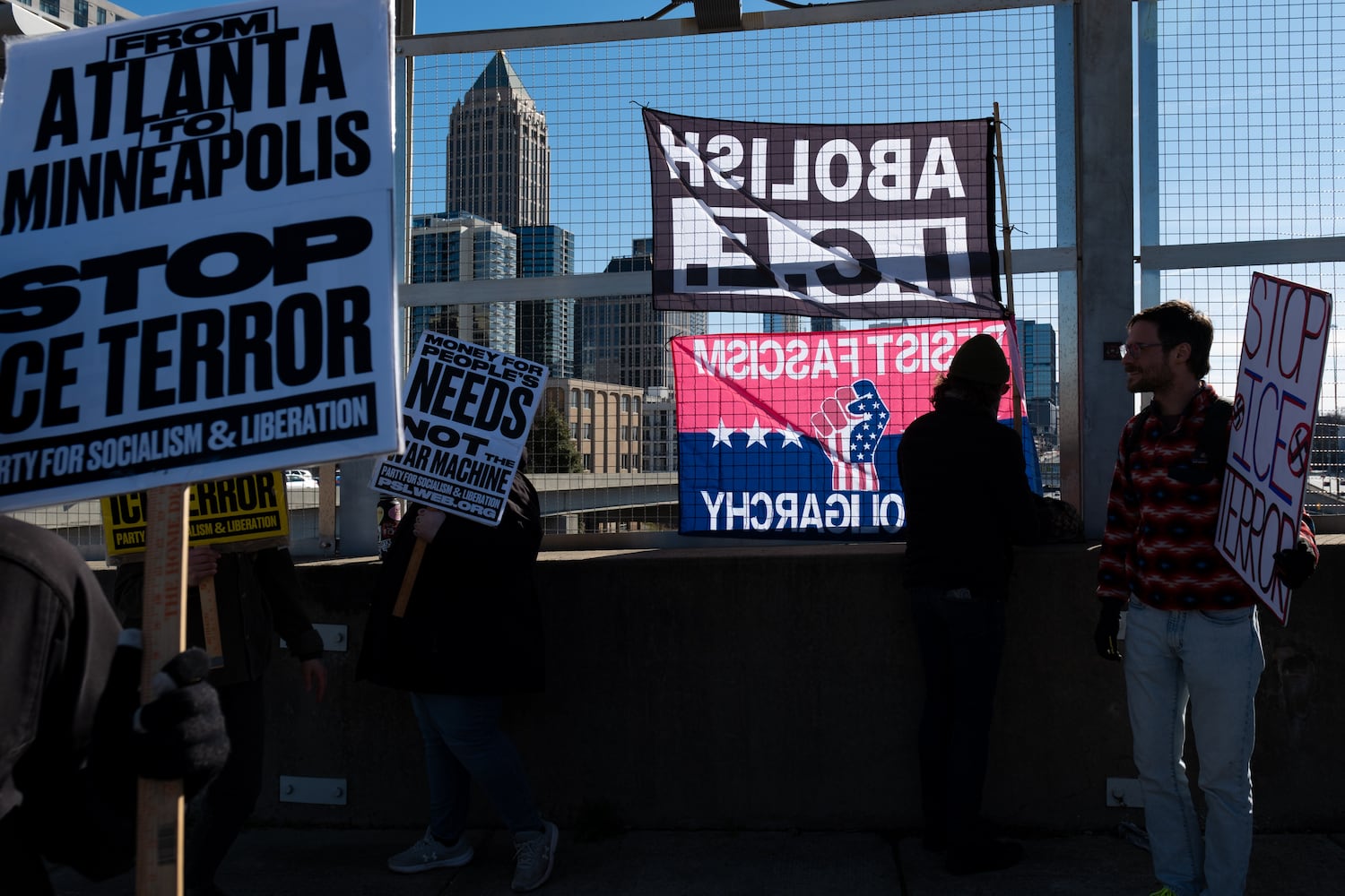 People gather on the 17th Street Bridge in Atlanta on Sunday, Jan. 11, 2026 to protest the ICE shooting of Renee Good and the US military action in Venezuela. Ben Gray for the Atlanta Journal-Constitution
