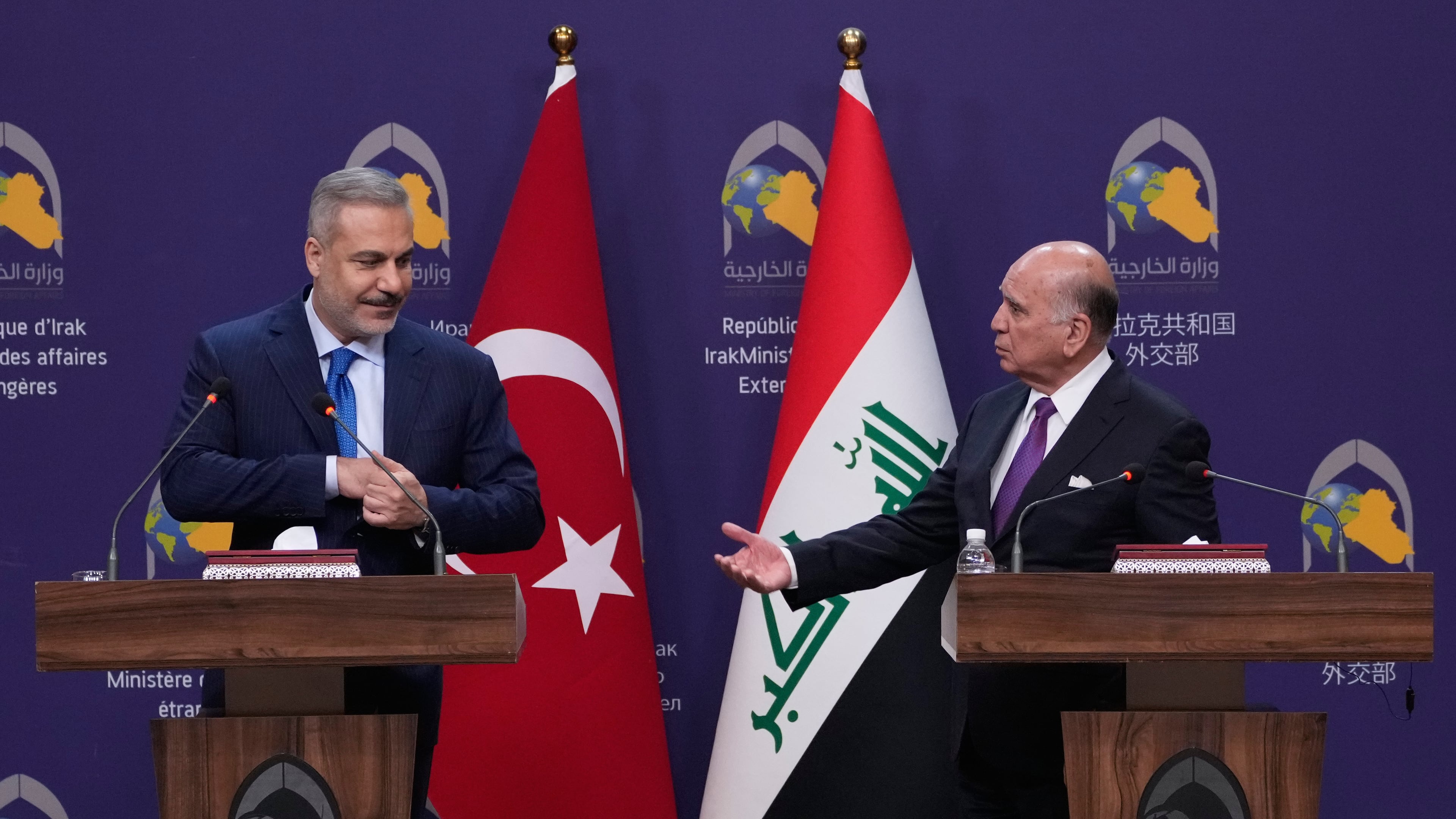 Turkish Foreign Minister Hakan Fidan, left, listens to his Iraqi counterpart Fuad Hussein during a news conference after a meeting at the foreign ministry in Baghdad, Iraq, Sunday, Nov. 2, 2025. (AP Photo/Hadi Mizban)