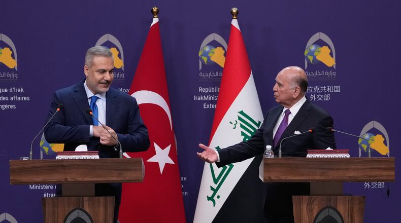 Turkish Foreign Minister Hakan Fidan, left, listens to his Iraqi counterpart Fuad Hussein during a news conference after a meeting at the foreign ministry in Baghdad, Iraq, Sunday, Nov. 2, 2025. (AP Photo/Hadi Mizban)
