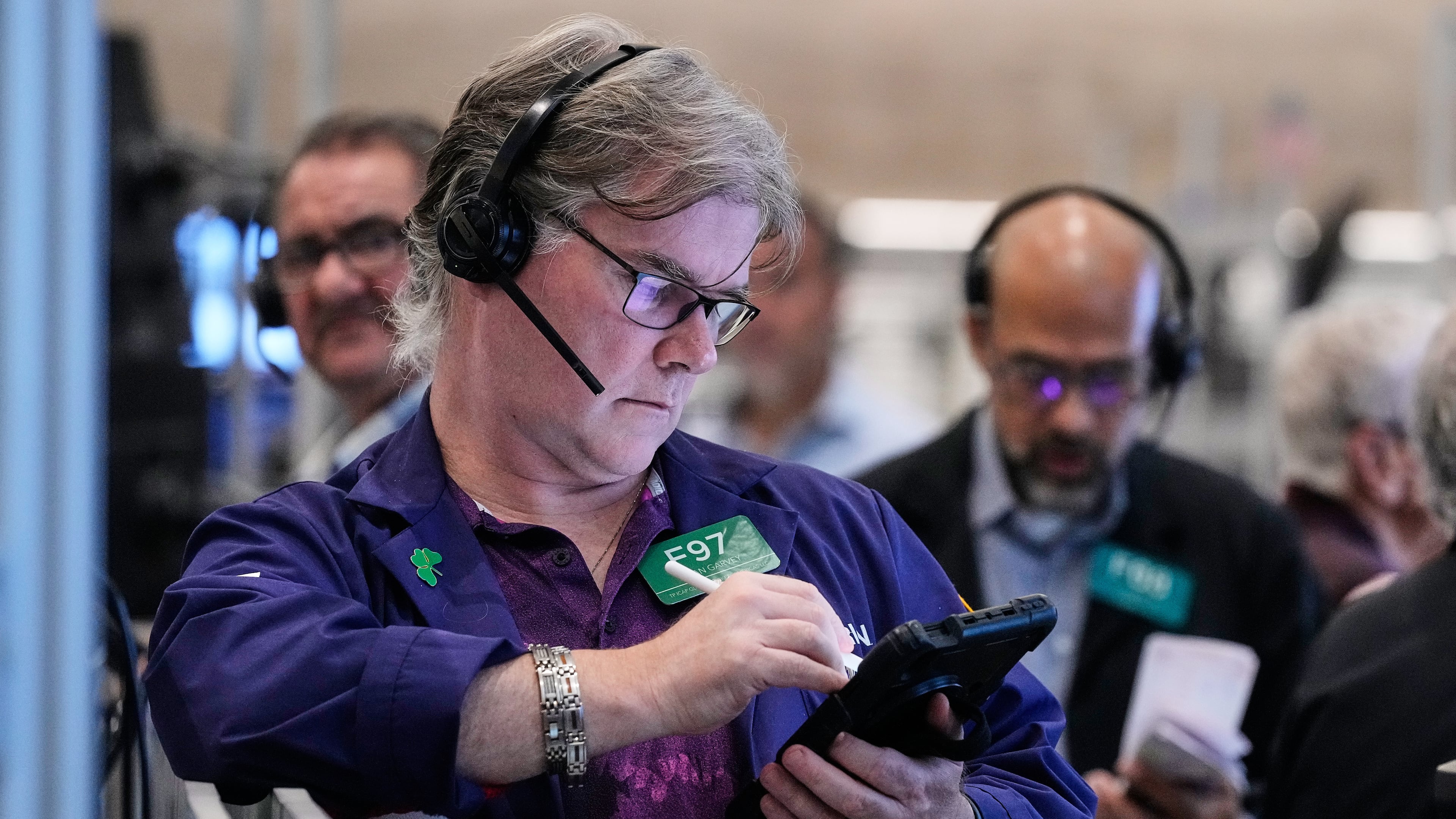 Options trader Brian Garvey, left, works on the floor of the New York Stock Exchange, Monday, Oct. 20, 2025. (AP Photo/Richard Drew)