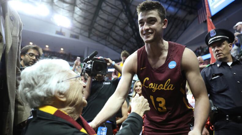 Loyola Ramblers guard Clayton Custer (13) reaches in for the hug with Sister Jean Dolores Schmidt after playing in the second round of the NCAA tournament against the Tennessee Volunteers at American Airlines Center on Saturday, March 17, 2018, in Dallas, Texas. Custer made a two-point basket with 3.6 seconds remaining, resulting in a 63-62 win to advance to the Sweet 16. (John J. Kim/Chicago Tribune/TNS)