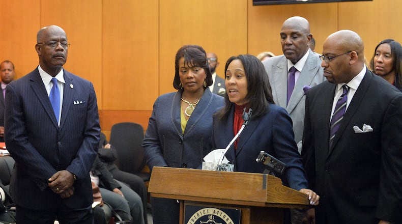 PROSECUTION TEAM SPEAKS--APRIL 14, 2015 ATLANTA Fulton County prosecutors Fani Willis and Clint Rucker speak as DA Paul Howard (left) and Dr. Bernice King listen, during a press conference following sentencing for 10 of the 11 defendants convicted of racketeering and other charges in the Atlanta Public Schools test-cheating trial. (Atlanta Journal-Constitution, Kent D. Johnson, Pool)