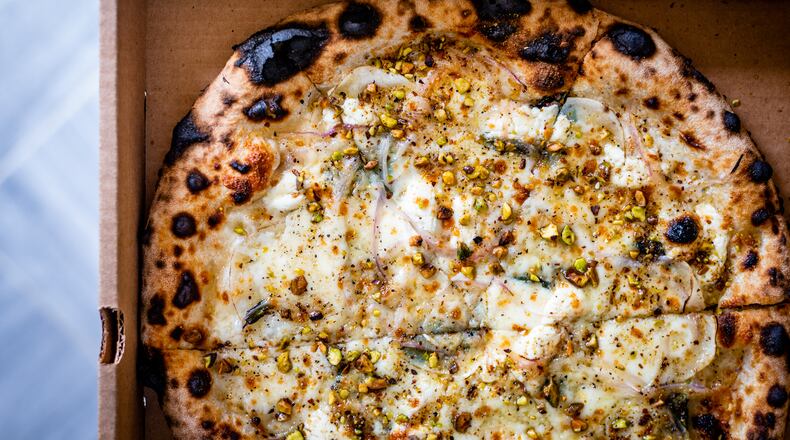 The potato pizza from Grana also features goat cheese, truffle honey, thinly-sliced red onion and pistachios. CONTRIBUTED BY HENRI HOLLIS