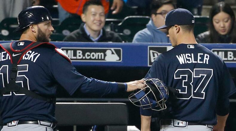 Braves catcher A.J. Pierzynski (left) congratulates starting pitcher Matt Wisler as they leave the field after eight shutout innings against the Mets. (AP Photo/Kathy Willens)