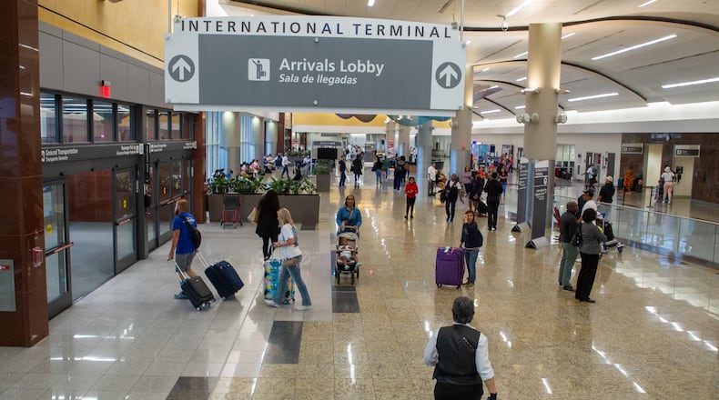 Travelers arrive and depart the international terminal at Hartsfield-Jackson Atlanta Airport Tuesday, May 10, 2022. (Steve Schaefer / steve.schaefer@ajc.com)