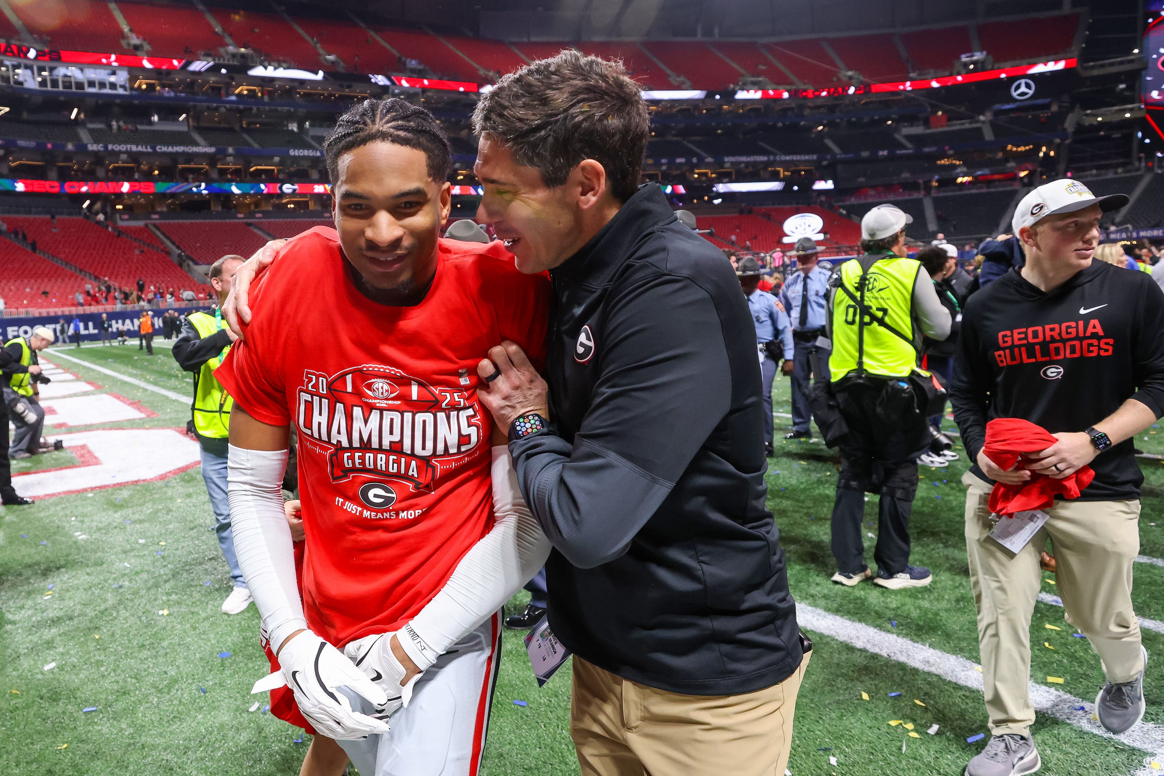 Georgia defensive back Daylen Everette celebrates with a staff member after their 28-7 victory over Alabama in the SEC Championship game at Mercedes-Benz Stadium, Saturday, Dec. 6, 2025, in Atlanta. (Jason Getz / AJC)