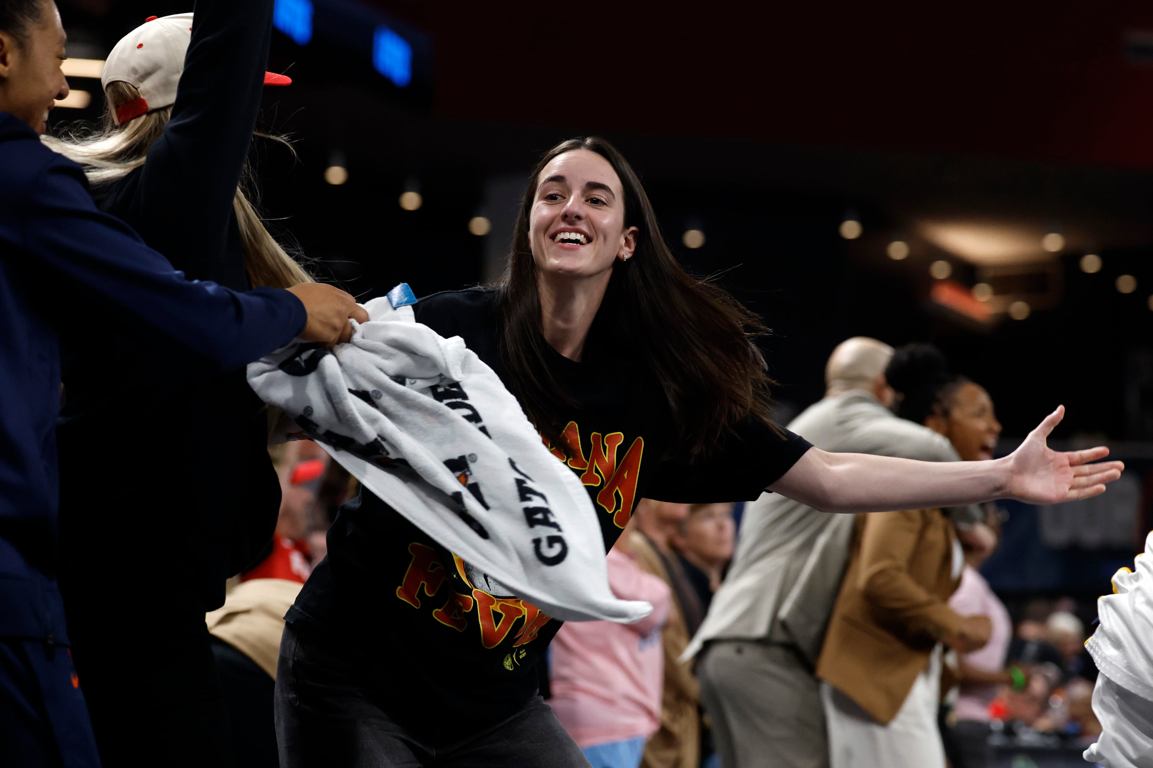 Indiana Fever guard Caitlin Clark, center, reacts after a score to take the lead over the Atlanta Dream during the second half of Game 3 in the first round of the WNBA basketball playoffs, Thursday, Sept. 18, 2025, in Atlanta. (AP Photo/Butch Dill)