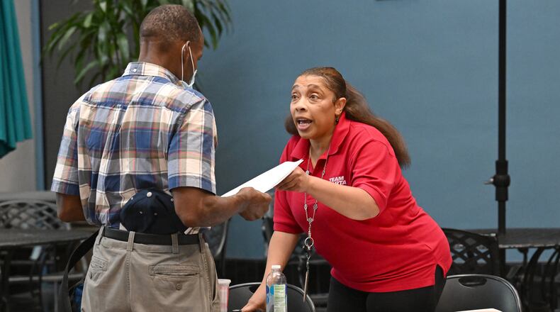 Arnita McCoy-Dhaamin (right), recruiting officer, helps a job seeker Maurice Franks during a job fair for bus operators and journeyman bus technicians at MARTA headquarters in July. Hyosub Shin / Hyosub.Shin@ajc.com)