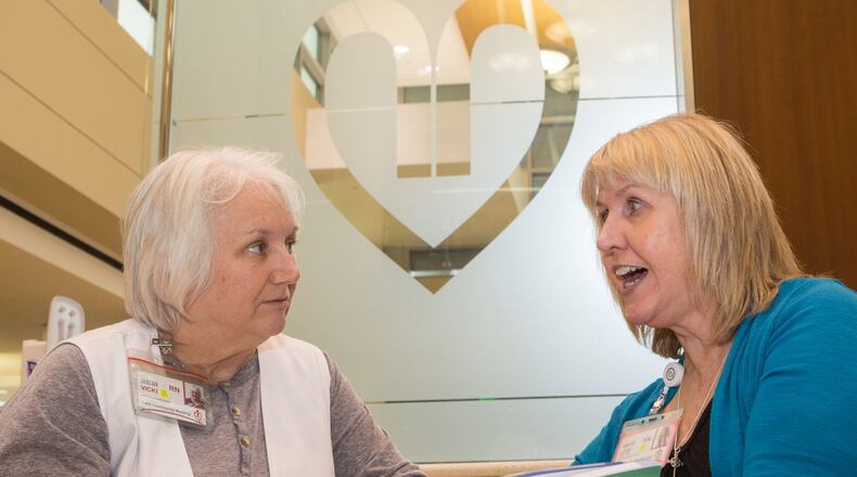 Faith Community Nurses Vicki Parker (left) and Lori Floyd talk in got lobby of the Gwinnett Medical Center in Lawrenceville. (Photo by Phil Skinner)