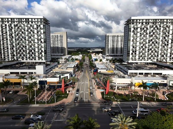 FILE - Cars pass through the area known as Downtown Doral, April 5, 2025, in Doral, Fla. (AP Photo/Rebecca Blackwell, File)
