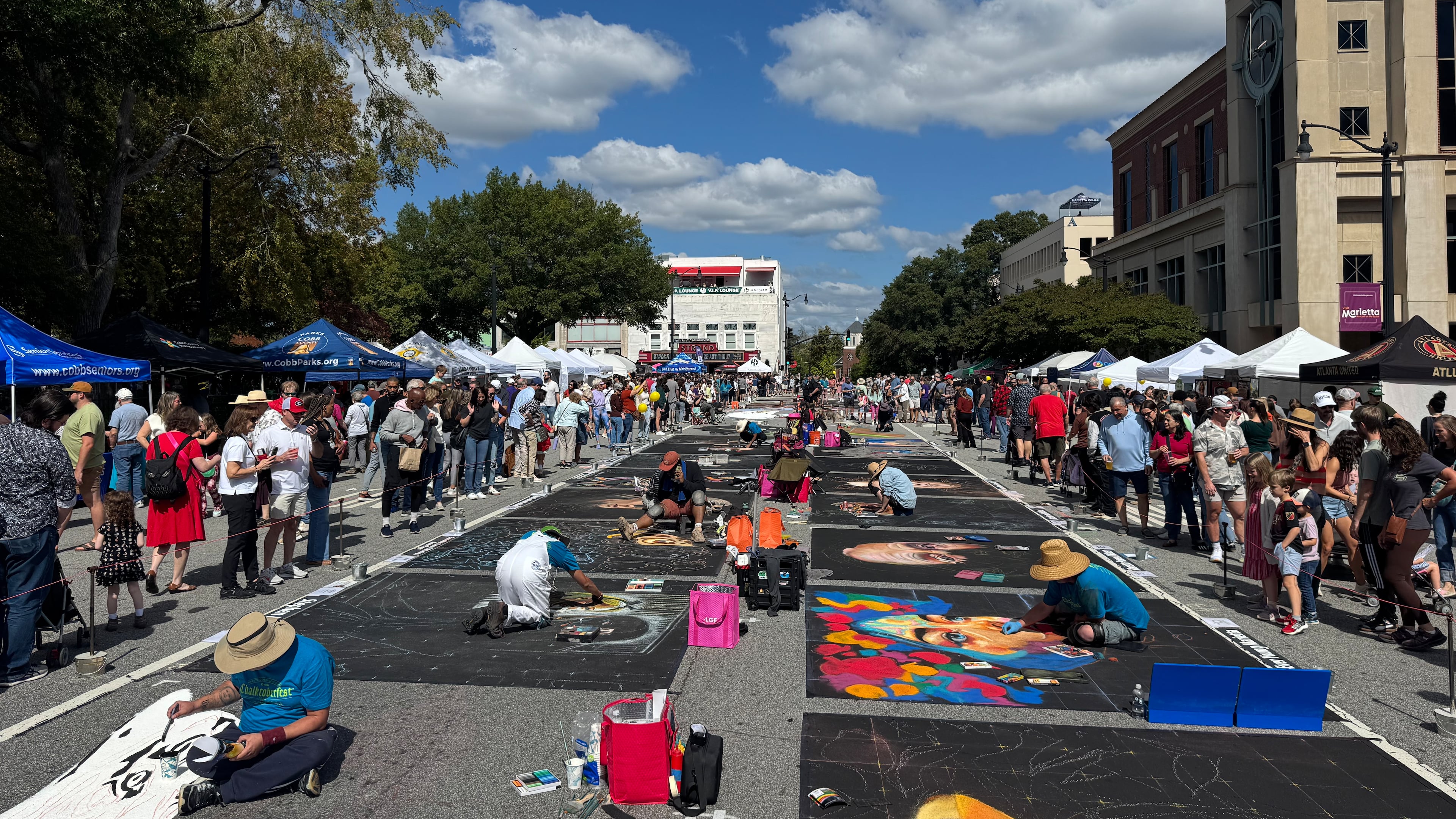 Professional artists work on their chalk drawings during Chalktoberfest on Saturday. (Caleb Groves/ AJC)