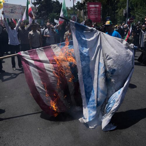 FILE - Iranian protestors burn representations of the Israeli and U.S. flags during a protest to condemn Israeli attacks on multiple cities across Iran, after the Friday prayers ceremony in Tehran, Iran, Friday, June 20, 2025. (AP Photo/Vahid Salemi), File)