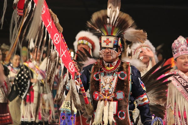 The grand entry of hundreds of Native American and Indigenous dancers begins with the staff procession during the annual Gathering of Nations powwow in Albuquerque, New Mexico, on Friday, May 25, 2025 (AP Photo/Susan Montoya Bryan)