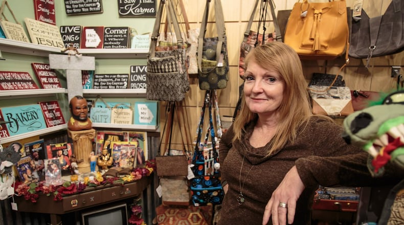 Owner Lori Ronca stands by a tribute to Mr. T. in her store HomeGrown Decatur on Small Business Saturday. STEVE SCHAEFER / SPECIAL TO THE AJC
