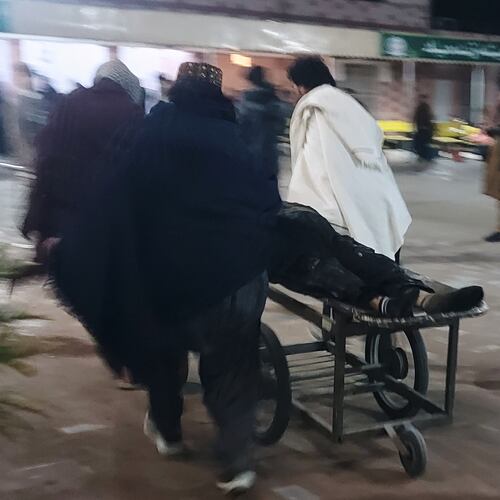 Volunteers transport an injured victim of suicide bombing at a wedding, Friday, Jan. 23, 2026, at a hospital in Dera Ismail Khan, Pakistan. (AP Photo/Kashif Naveed)
