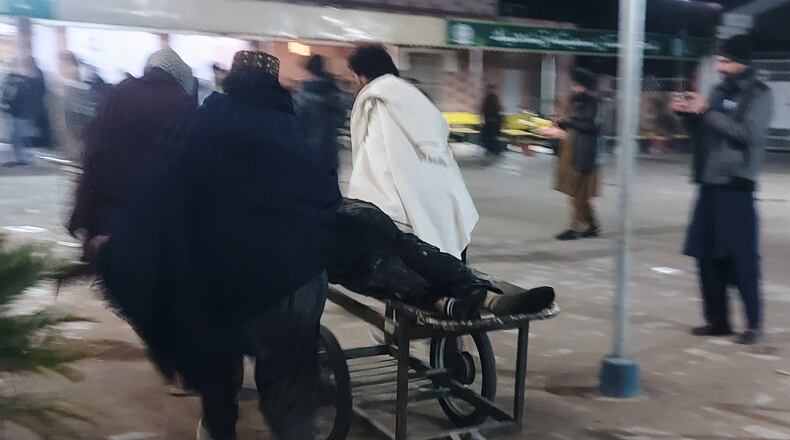 Volunteers transport an injured victim of suicide bombing at a wedding, Friday, Jan. 23, 2026, at a hospital in Dera Ismail Khan, Pakistan. (AP Photo/Kashif Naveed)