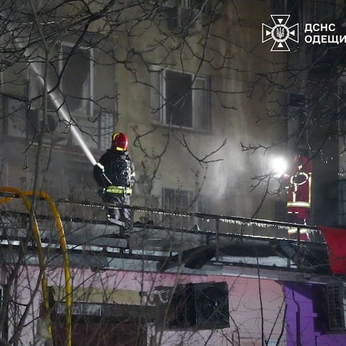 In this photo provided by the Ukrainian Emergency Service, emergency services personnel work to extinguish a fire following a Russian attack in Odesa, Ukraine, Wednesday, Dec. 31, 2025. (Ukrainian Emergency Service via AP)