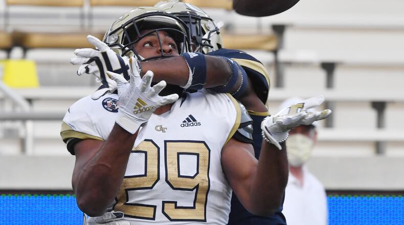 April 23, 2021 Atlanta - Georgia Tech running back Bruce Jordan-Swilling (29) makes a touchdown pass under pressure from behind by Georgia Tech defensive back Zamari Walton (7) during the 2021 Spring Game at Georgia Tech's Bobby Dodd Stadium in Atlanta on Friday, April 23, 2021. (Hyosub Shin / Hyosub.Shin@ajc.com)