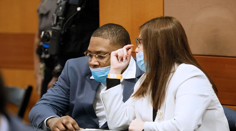Nicole Fegan talks with her client, Tenquarius Mender, during the Young Slime Life gang trial. On Feb. 14, 2023, prosecutors filed a motion to sever the trial of Mender from that of the other Young Slime Life co-defendants after Fegan made the court aware of her imminent personal leave of absence due to pregnancy. (Miguel Martinez/The Atlanta Journal-Constitution/TNS)