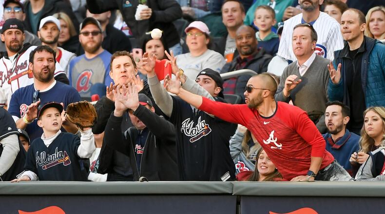 Fans reach for a foul ball at SunTrust Park earlier this season.