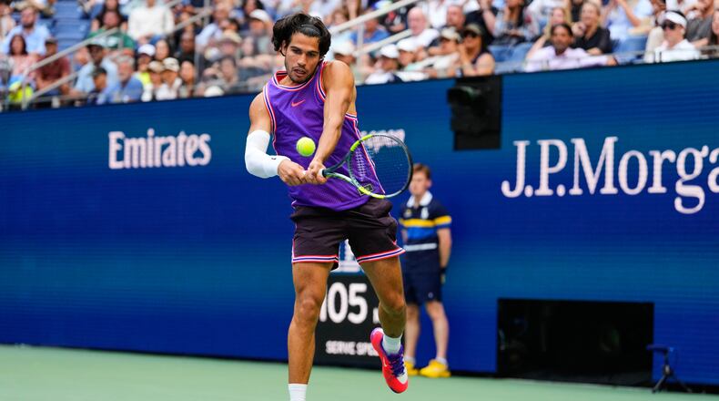 Carlos Alcaraz, of Spain, returns the ball during a mixed doubles match at the U.S. Open tennis championships, Tuesday, Aug. 25, 2026, in New York. (AP Photo/Yuki Iwamura)