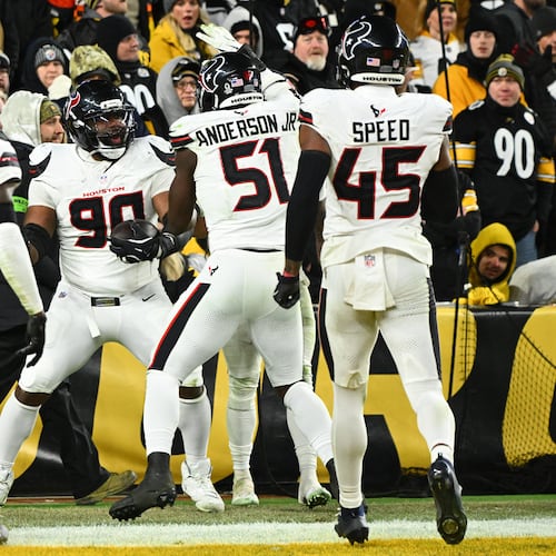 Houston Texans defensive tackle Sheldon Rankins (90) celebrates with cornerback Tremon Smith (11), defensive end Will Anderson Jr. (51) and linebacker E.J. Speed (45) after a touchdown during the second half of an NFL wild-card playoff football game against the Pittsburgh Steelers, Monday, Jan. 12, 2026, in Pittsburgh. (AP Photo/Justin Berl)